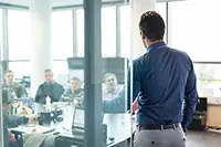 Leader giving a presentation to a team in a meeting room, demonstrating effective presentation skills to inspire and motivate